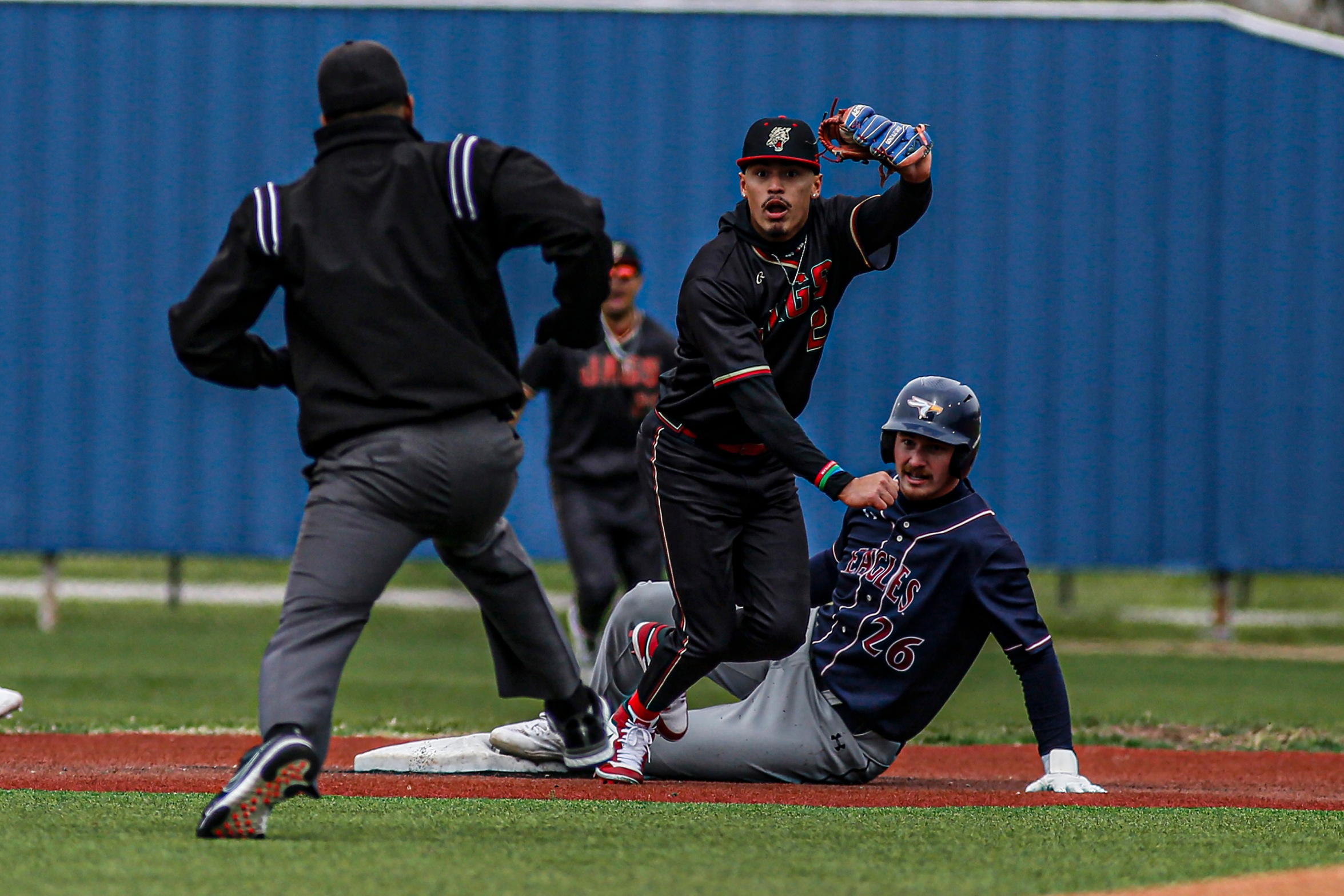 UHV's Jean Michael Gonzalez shows the umpire the ball after tagging out an A&M-Texarkana baserunner during an RRAC game at Riverside Stadium on Feb. 17, 2024. (Estelle Flanagan/UHV Athletics)