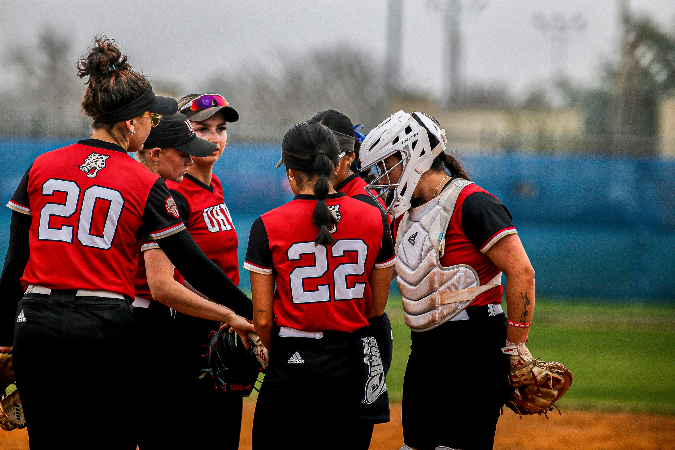 The UHV softball team huddles up before an inning during a game against Missouri Baptist at the Victoria Youth Sports Complex on Tuesday, Feb. 11, 2025. (Lily Standridge/UHV Athletics)